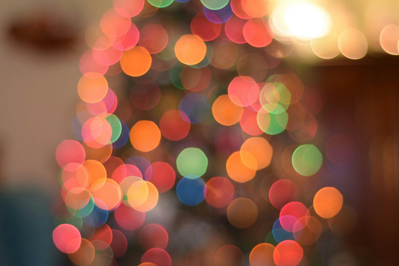Vibrant bokeh of Christmas tree lights creating a festive atmosphere.